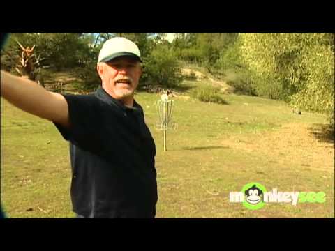 Frisbee expert Tom Schot demonstrates disc golf throwing accuracy.